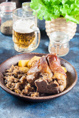 Pork knuckle with fried sauerkraut and baked potatoes