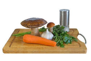Mushrooms, garlic, salt and herbs on a cutting board on a white background.

