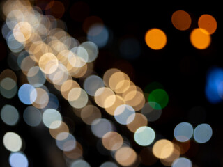 Abstract bokeh night light background, blurred lights traces from cars on road, defocused city traffic on street at night