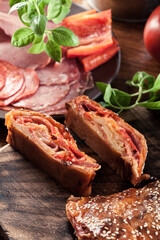 Italian stromboli stuffed with ham, salami and cheese