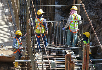 MALACCA, MALAYSIA -MAY 16, 2016: Construction workers fabricating steel reinforcement bar at the construction site in Malacca, Malaysia. The reinforcement bar was ties together using tiny wire.  
