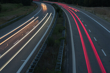 German autobahn in the dark with the light trails of traffic.