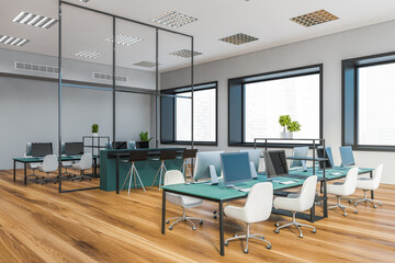 Grey open space office corner with blue tables