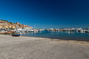 Naklejka na ściany i meble quay where boats go to sea in porto santo stefano