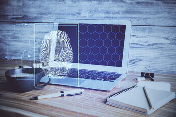 Computer on desktop in office with finger print drawing. Double exposure. Concept of business data security.