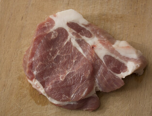 The peace of meat on wooden desk