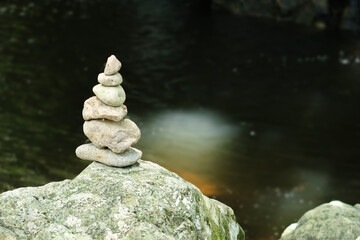 Fototapeta na wymiar Stone tower rocks arranged at waterfall, Zen balance concept.
