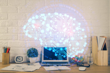 Double exposure of work space with computer and human brain drawing hologram. Brainstorm concept.