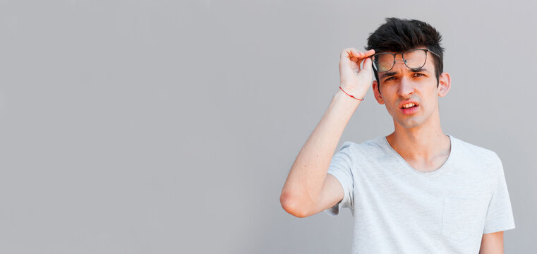 Portrait of shocked young man and glasses with open mouth.