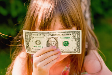 Business in my mind! Young beautiful girl with one US Dollar banknote.