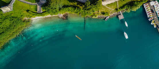 Ledro lake in Trentino Alto Adige, Italy. Top view of the lake with the prehistoric canoe. Prehistoric canoe reconstruction