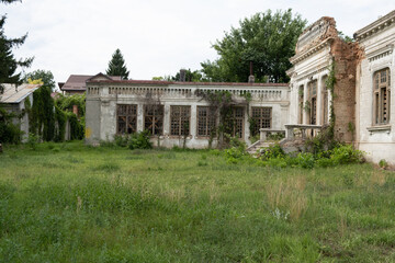 Fototapeta na wymiar Old house with a unique design in baroque style in Romania abandoned and allowed to grow grass next to it owner Dimitrie Razlet 