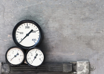 pressure gauges on a gray surface. vintage appliances