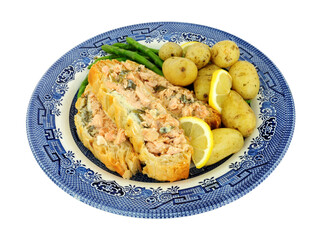 Sliced puff pastry covered salmon Wellington meal with new potatoes and asparagus isolated on a white background
