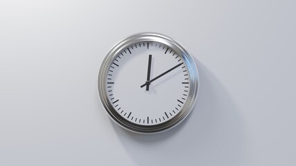 Glossy chrome clock on a white wall at ten past twelve. Time is 00:10 or 12:10