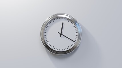 Glossy chrome clock on a white wall at twenty past twelve. Time is 00:20 or 12:20