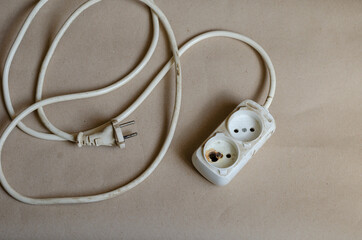 Electrical plug condition ,outlet after shock on brown background.
