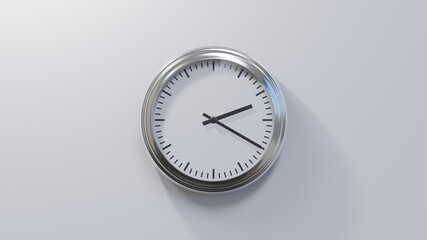 Glossy chrome clock on a white wall at twenty past two. Time is 02:20 or 14:20