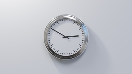 Glossy chrome clock on a white wall at ten to three. Time is 02:50 or 14:50