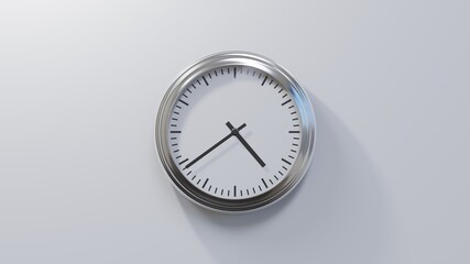 Glossy chrome clock on a white wall at thirty-nine past four. Time is 04:39 or 16:39