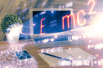 Desktop computer background and formula hologram writing. Double exposure. Education concept.