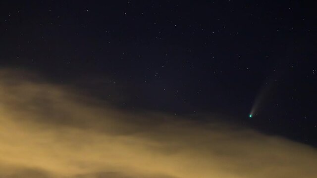 Time lapse of Comet NEOWISE or C/2020 F3 (NEOWISE) with cloud in the night sky.
