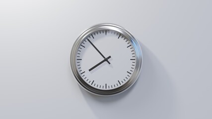 Glossy chrome clock on a white wall at fifty-three past seven. Time is 07:53 or 19:53