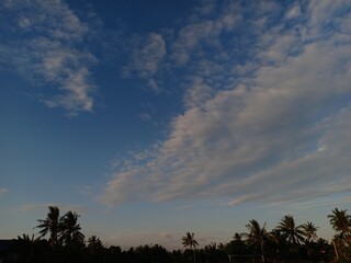 white clouds against a blue sky background