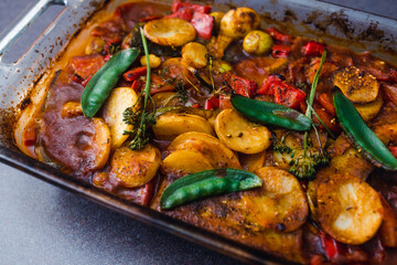 plant-based food, vegan tomato potato and snowpeas roasted in oven tray
