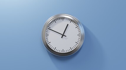 Glossy chrome clock on a blue wall at forty-nine past twelve. Time is 00:49 or 12:49