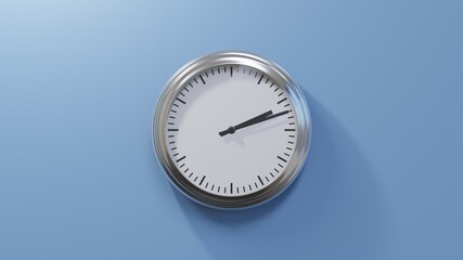 Glossy chrome clock on a blue wall at twelve past two. Time is 02:12 or 14:12