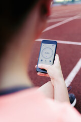 Woman using a running App in smart phone