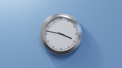 Glossy chrome clock on a blue wall at forty-seven past three. Time is 03:47 or 15:47