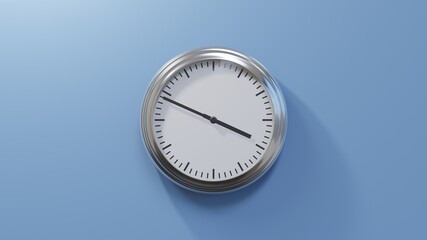 Glossy chrome clock on a blue wall at forty-nine past three. Time is 03:49 or 15:49