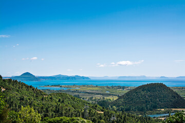 View from above over great Lake Taupo and surrounding mountains on a beautiful summer day