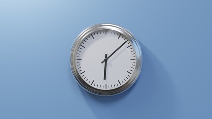 Glossy chrome clock on a blue wall at eight past six. Time is 06:08 or 18:08