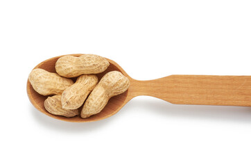 inshell peanuts lies in a wooden spoon, tasty fruit is isolated on a white background