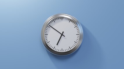 Glossy chrome clock on a blue wall at fifty-one past six. Time is 06:51 or 18:51