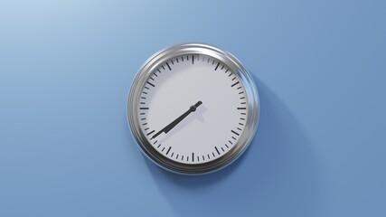 Glossy chrome clock on a blue wall at thirty-nine past seven. Time is 07:39 or 19:39