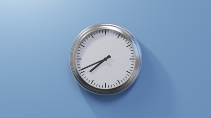 Glossy chrome clock on a blue wall at forty-one past seven. Time is 07:41 or 19:41