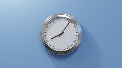 Glossy chrome clock on a blue wall at six past eight. Time is 08:06 or 20:06