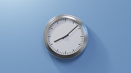 Glossy chrome clock on a blue wall at eight past eight. Time is 08:08 or 20:08