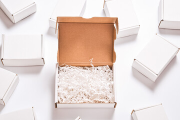 White paper filler in cardboard box, set of white carton boxes