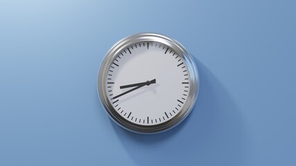 Glossy chrome clock on a blue wall at forty-one past eight. Time is 08:41 or 20:41