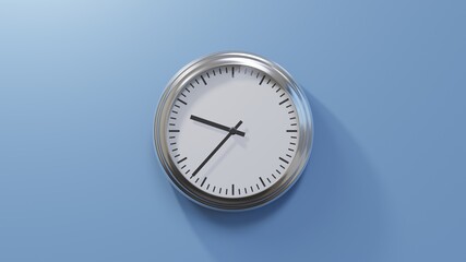 Glossy chrome clock on a blue wall at thirty-seven past nine. Time is 09:37 or 21:37