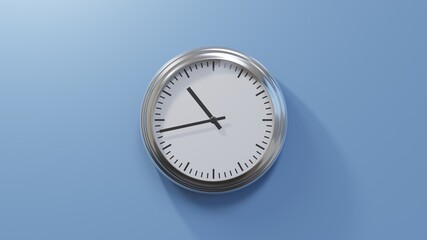 Glossy chrome clock on a blue wall at forty-three past ten. Time is 10:43 or 22:43