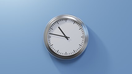 Glossy chrome clock on a blue wall at forty-seven past ten. Time is 10:47 or 22:47