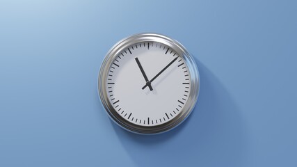 Glossy chrome clock on a blue wall at eight past eleven. Time is 11:08 or 23:08