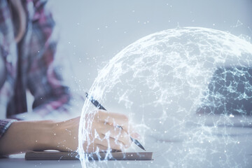 Social network theme hologram over hands taking notes background. Concept of global international people connect. Double exposure