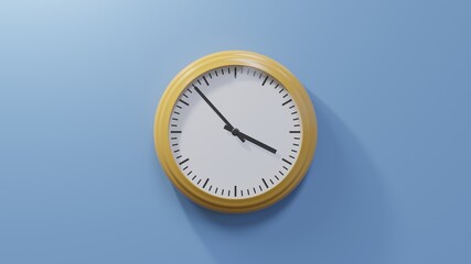 Glossy orange clock on a blue wall at fifty-three past three. Time is 03:53 or 15:53